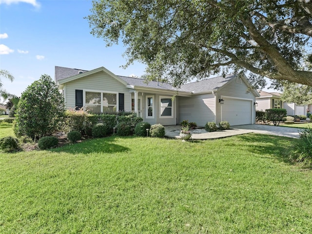 ranch-style home featuring a garage and a front yard