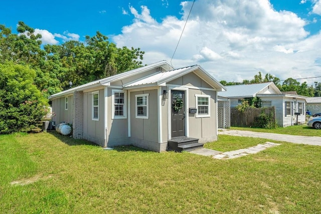 view of outbuilding with central AC unit and a yard