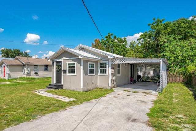 view of front of home with a front yard and a carport