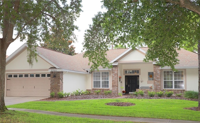 ranch-style house with a garage, stucco siding, a front lawn, and brick siding