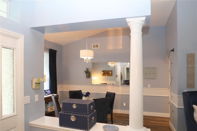 dining space with lofted ceiling, visible vents, decorative columns, and wood finished floors