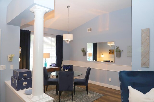 dining space featuring vaulted ceiling, dark wood-type flooring, decorative columns, and a chandelier