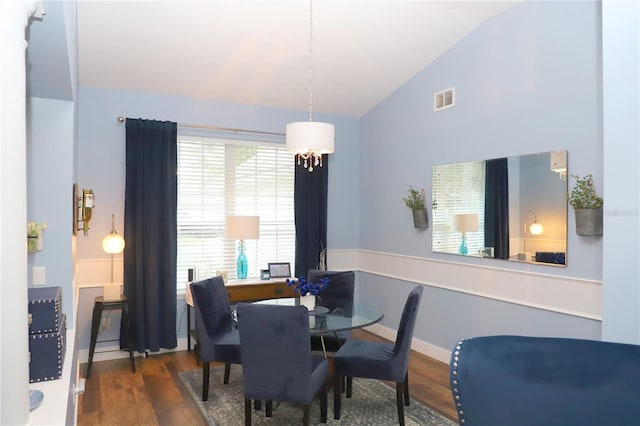 dining area with lofted ceiling, wood finished floors, visible vents, and baseboards