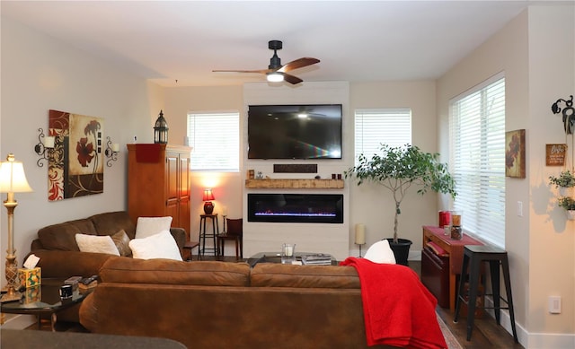 living room with ceiling fan and hardwood / wood-style flooring