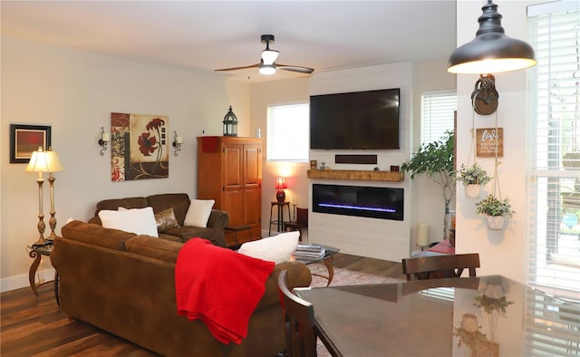 living room featuring plenty of natural light, ceiling fan, and dark hardwood / wood-style floors