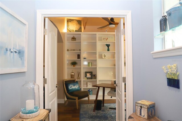 interior space with ceiling fan and wood-type flooring