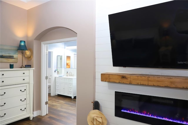 interior space with sink, dark hardwood / wood-style flooring, and ensuite bathroom