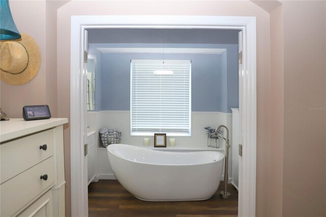 bathroom with a bath, hardwood / wood-style flooring, and vanity