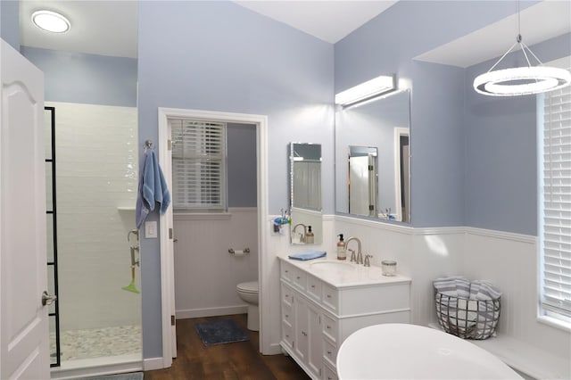 bathroom featuring a shower with door, toilet, hardwood / wood-style flooring, and vanity