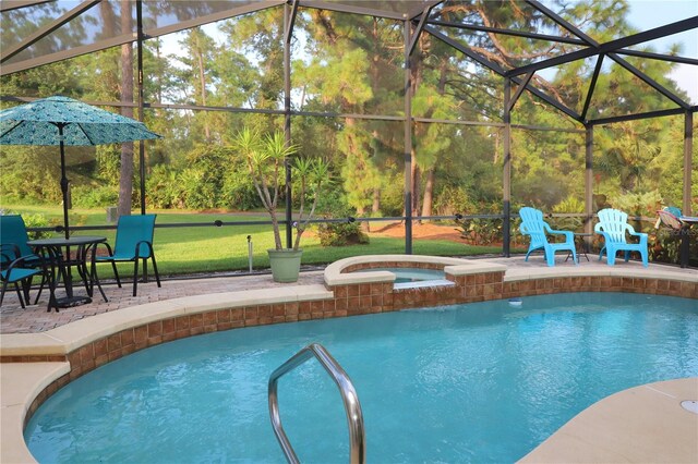 pool featuring an in ground hot tub, a patio area, and a lanai