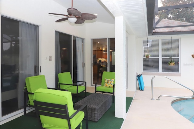 view of patio / terrace featuring ceiling fan and glass enclosure