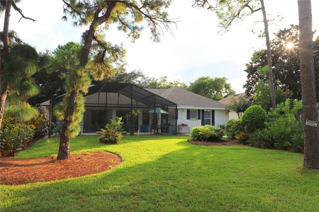 back of property featuring a yard and a lanai