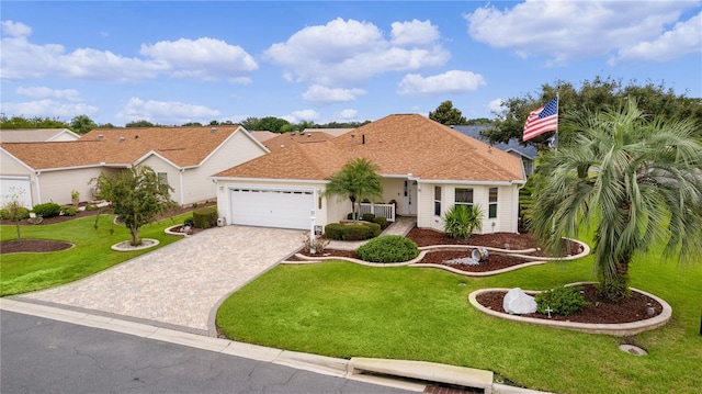 view of front of home featuring a garage and a front yard