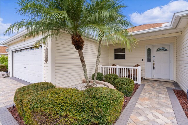 3401 Fairfield St, The Villages, FL 32162 - view of exterior entry featuring driveway, covered porch, and a garage