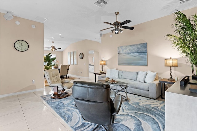 living room with ceiling fan, light tile patterned floors, and lofted ceiling