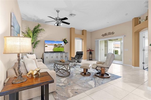 tiled living room featuring ceiling fan