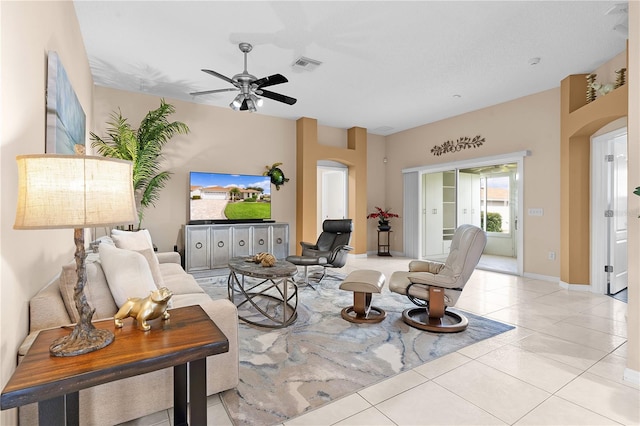 3401 Fairfield St, The Villages, FL 32162 - living room featuring arched walkways, light tile patterned flooring, visible vents, and a ceiling fan