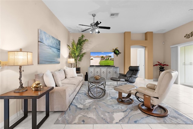 tiled living room with ceiling fan