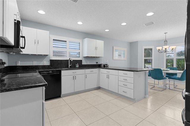 kitchen featuring dishwasher, white cabinetry, range, light tile patterned floors, and kitchen peninsula