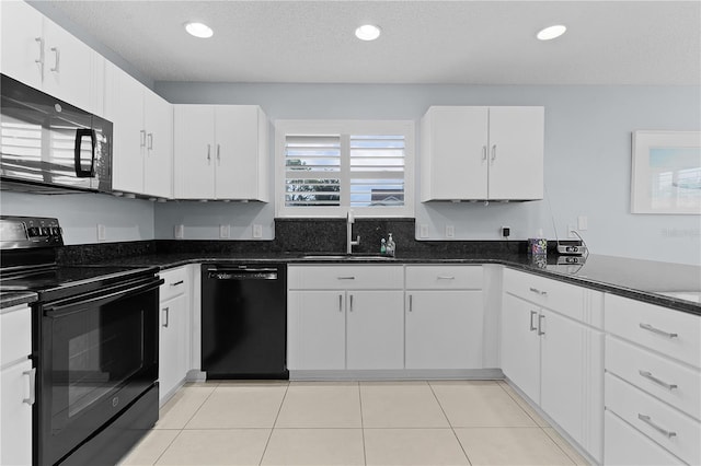 3401 Fairfield St, The Villages, FL 32162 - kitchen with a textured ceiling, white cabinets, a sink, black appliances, and light tile patterned floors