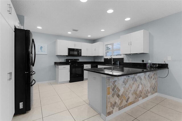 3401 Fairfield St, The Villages, FL 32162 - kitchen featuring light tile patterned floors, dark countertops, visible vents, a peninsula, and black appliances