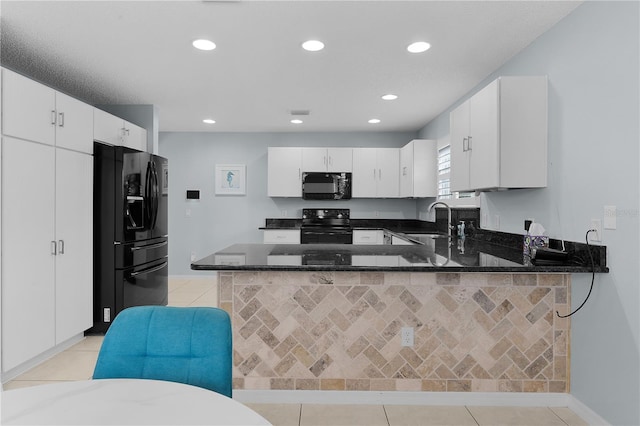 kitchen with dark stone counters, sink, white cabinetry, kitchen peninsula, and black appliances