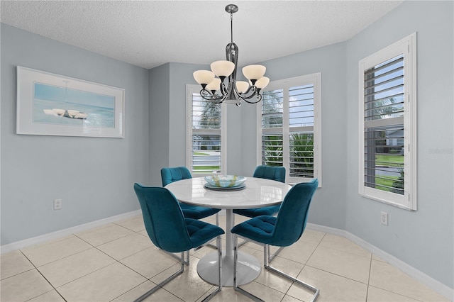 3401 Fairfield St, The Villages, FL 32162 - dining area with an inviting chandelier, light tile patterned floors, baseboards, and a textured ceiling
