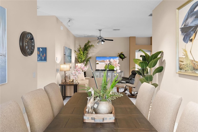 dining space with ceiling fan and wood-type flooring