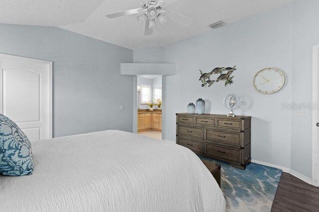 3401 Fairfield St, The Villages, FL 32162 - bedroom with vaulted ceiling, baseboards, a textured ceiling, visible vents, and wood finished floors