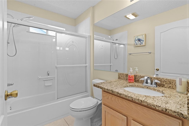 full bathroom featuring a textured ceiling, toilet, vanity, and combined bath / shower with glass door