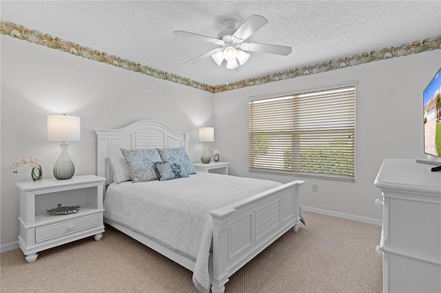 carpeted bedroom featuring a textured ceiling and ceiling fan