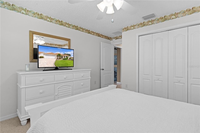 3401 Fairfield St, The Villages, FL 32162 - carpeted bedroom featuring a closet, a textured ceiling, baseboards, visible vents, and ceiling fan