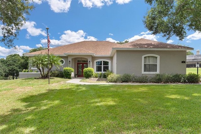 mediterranean / spanish home featuring a front lawn