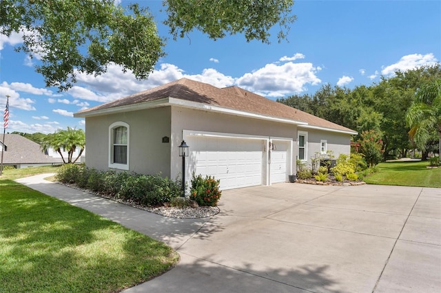 view of side of property featuring a yard and a garage