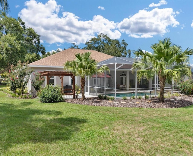 back of property with glass enclosure and a lawn