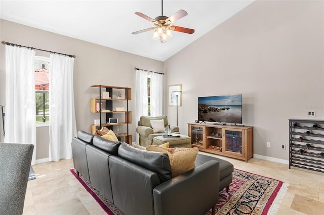 living room with high vaulted ceiling, ceiling fan, and a healthy amount of sunlight