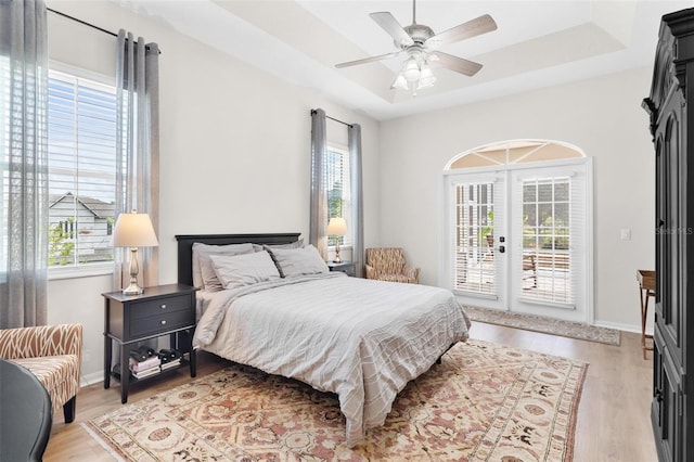 bedroom featuring multiple windows, ceiling fan, and light hardwood / wood-style floors