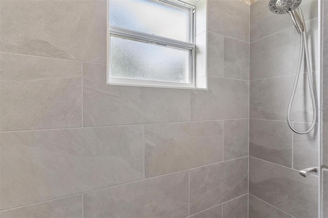 bathroom with tiled shower