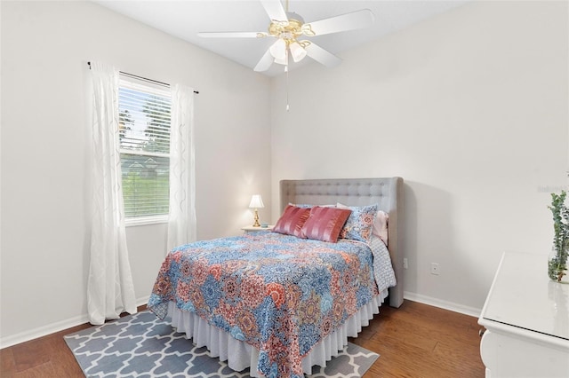 bedroom with dark wood-type flooring and ceiling fan