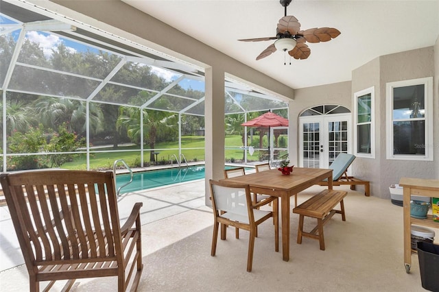 sunroom / solarium featuring french doors, a swimming pool, and ceiling fan