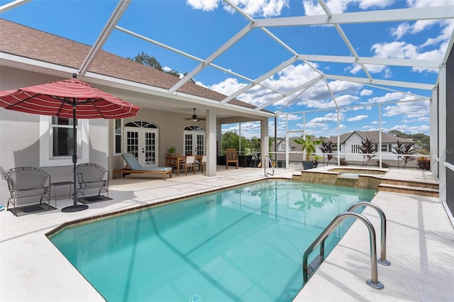 view of swimming pool with a lanai, ceiling fan, a patio area, and french doors