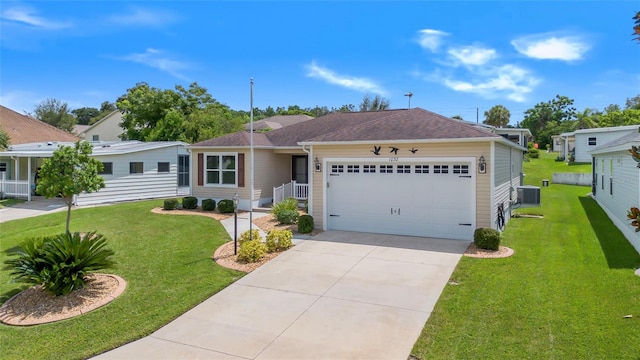 ranch-style house featuring a garage, central air condition unit, and a front lawn