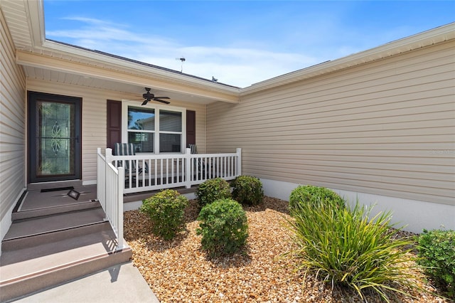 entrance to property with ceiling fan and covered porch