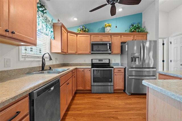 kitchen with ceiling fan, light wood-type flooring, high vaulted ceiling, appliances with stainless steel finishes, and sink