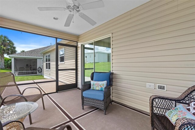 sunroom / solarium with plenty of natural light and ceiling fan