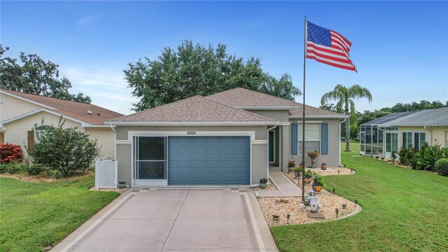 32915 Crooked Oaks Ln, Leesburg, FL 34748 - single story home with driveway, a garage, roof with shingles, a front lawn, and stucco siding
