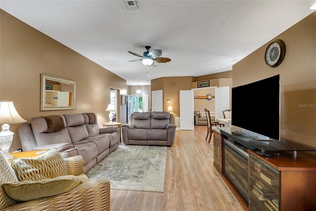 32915 Crooked Oaks Ln, Leesburg, FL 34748 - living area featuring a ceiling fan, visible vents, a textured ceiling, and light wood finished floors