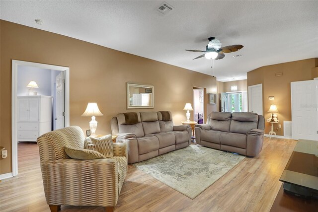 32915 Crooked Oaks Ln, Leesburg, FL 34748 - living area with light wood finished floors, visible vents, ceiling fan, a textured ceiling, and baseboards