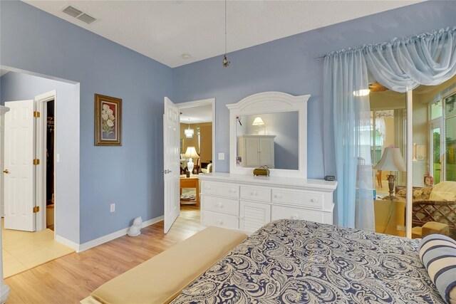 32915 Crooked Oaks Ln, Leesburg, FL 34748 - bedroom with light wood-style floors, baseboards, and visible vents