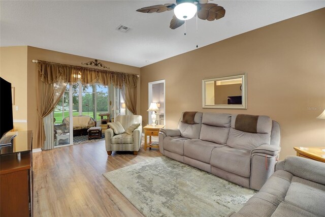 32915 Crooked Oaks Ln, Leesburg, FL 34748 - living area featuring light wood-type flooring, visible vents, ceiling fan, and baseboards